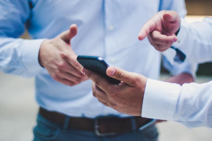 Proximity person holding black smartphone